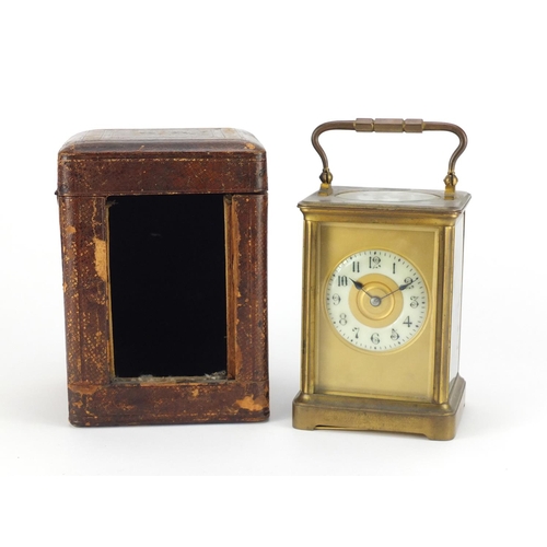 2351 - Large French brass cased carriage clock with enamelled chapter ring, Arabic numerals and leather tra... 