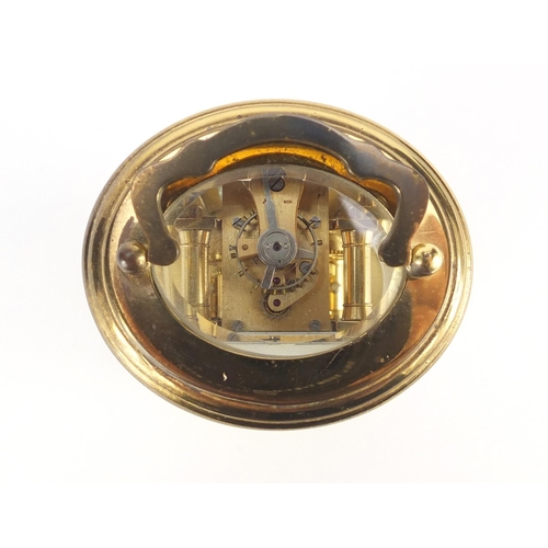 2243 - Miniature brass cased oval carriage clock, the dial having Roman numerals, impressed LD to the back ... 