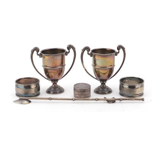 2652 - Silver items including a pair of miniature twin handled trophies, pair of napkin rings and an opium ... 