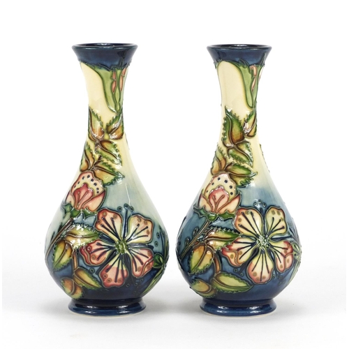 2196 - Pair of Moorcroft pottery vases, hand painted with stylised flowers and foliage, each 17cm high