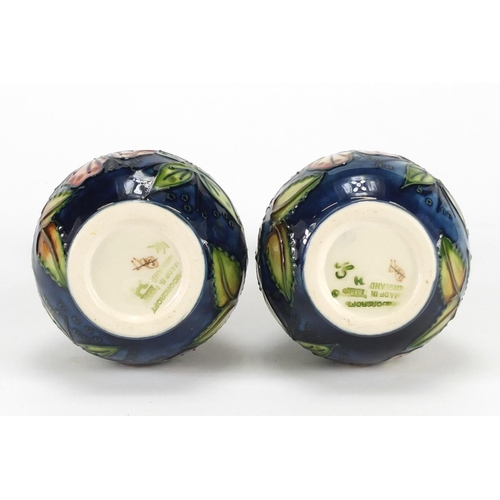 2196 - Pair of Moorcroft pottery vases, hand painted with stylised flowers and foliage, each 17cm high