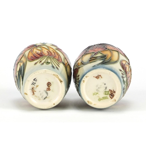 2255 - Pair of Moorcroft pottery vases hand painted with stylised flowers, each 9.5cm high