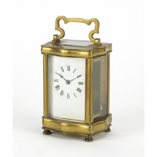 2250 - French brass cased serpentine fronted carriage clock with enamelled dial and Roman numerals, 12cm hi... 