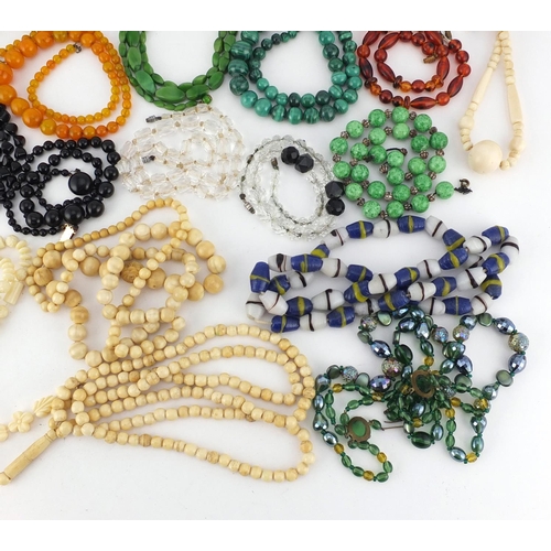 3040 - Vintage and later necklaces including ivory beads, malachite, crystal, amber coloured beads and cora... 