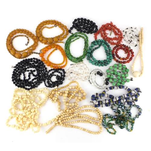 3040 - Vintage and later necklaces including ivory beads, malachite, crystal, amber coloured beads and cora... 