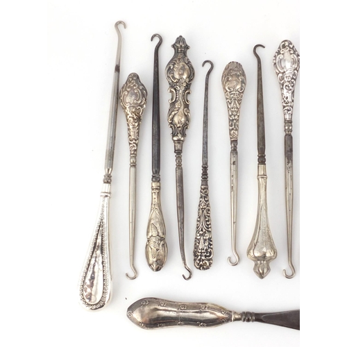 2639 - Collection of Victorian and later silver handled button hooks, some embossed with putti, various hal... 