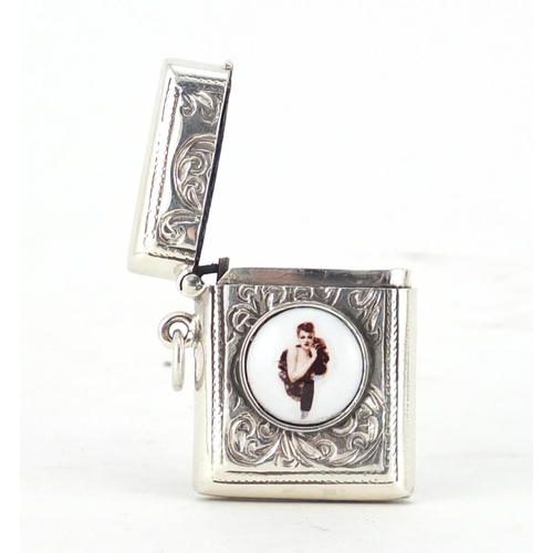 2635 - Sterling silver vesta with enamelled risqué female plaque, 3.8cm high, 18.0g