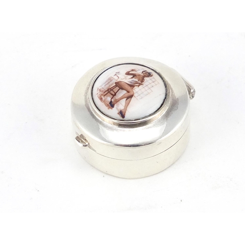 2672 - Sterling silver pill box with enamelled risqué female panel, 2.5cm in diameter, 10.4g