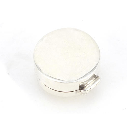 2672 - Sterling silver pill box with enamelled risqué female panel, 2.5cm in diameter, 10.4g