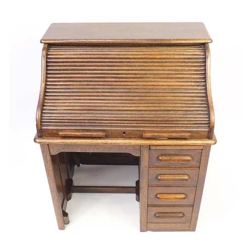 2033 - Oak tambour front roll top desk with four drawers to the base, 114cm H x 90cm W x 66cm D