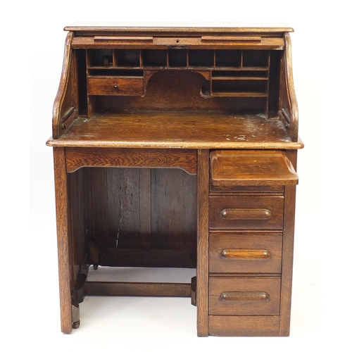 2033 - Oak tambour front roll top desk with four drawers to the base, 114cm H x 90cm W x 66cm D
