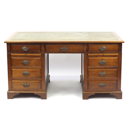 2094 - Mahogany twin pedestal captain's desk with tooled leather insert above a series of drawers and brush... 