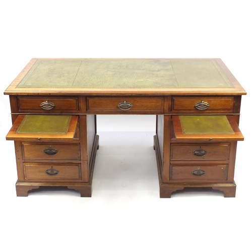 2094 - Mahogany twin pedestal captain's desk with tooled leather insert above a series of drawers and brush... 