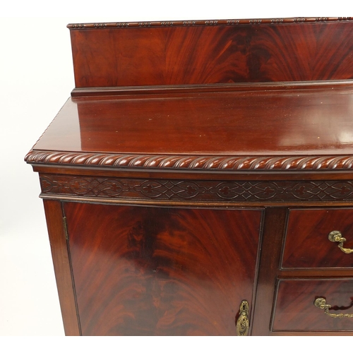 2021 - Chippendale style mahogany bow front sideboard fitted with two cupboard doors and three central draw... 