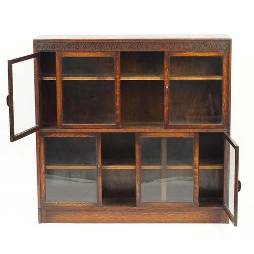 2037 - 1920's oak sectional bookcase by Gumm with four doors and two sliding panels, 125cm H x 128cm W x 25... 