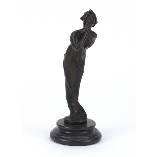 2490 - Patinated bronze study of an Art Deco female, raised on a circular marble base, 21cm high