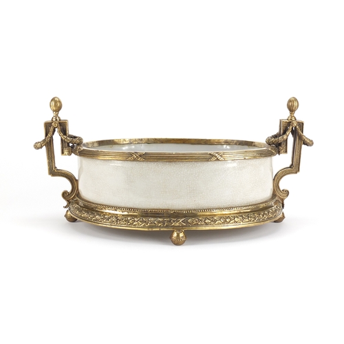 2209 - Four footed crackle glazed centre piece with twin handles, having ornate brass mounts, 42cm wide