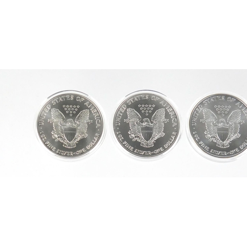 2705 - Four United States of America silver eagle dollars with certificates comprising dates 2001, 2002, 20... 
