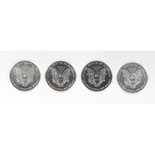 2701 - Four United States of America coloured silver dollars, with certificates comprising dates two 2001 a... 