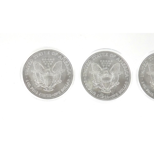 2703 - Three 2005 United States of America coloured  silver dollars, with certificates