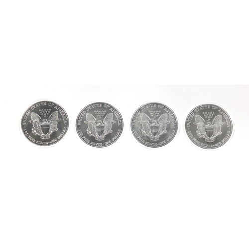 2704 - Four United States of America silver Luna eagle dollars, with certificates comprising dates 2001, 20... 
