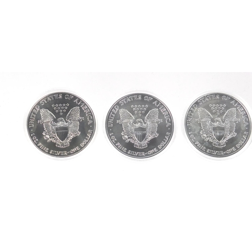 2704 - Four United States of America silver Luna eagle dollars, with certificates comprising dates 2001, 20... 