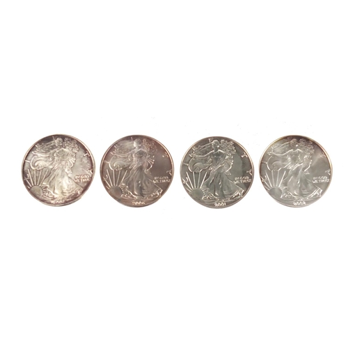 2712 - Four United States of America silver dollars, comprising dates 2001, 2002, 2006 and 2006