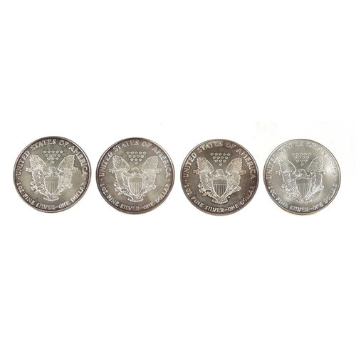 2712 - Four United States of America silver dollars, comprising dates 2001, 2002, 2006 and 2006