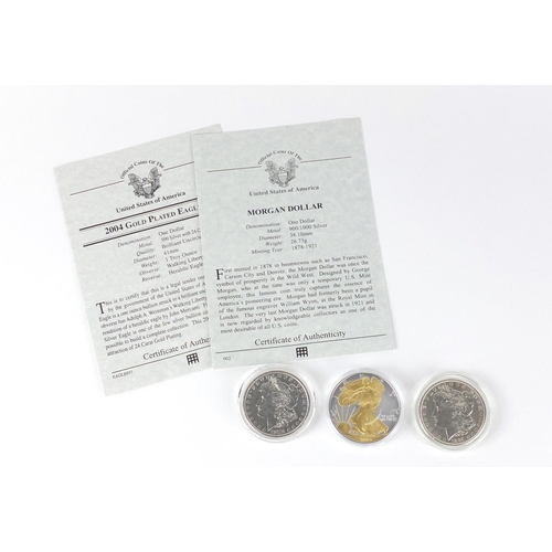 2706 - Three United States of America silver dollars, two with certificates comprising two Morgan dollars d... 