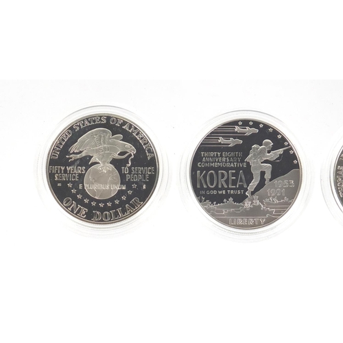 2707 - Five United States of America silver dollars  with certificates including Korean War, World War II a... 