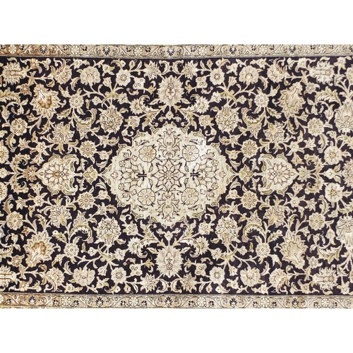2026 - Rectangular Persian silk rug having an all over floral design onto a midnight blue ground, 160cm x 1... 