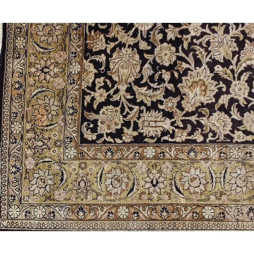 2026 - Rectangular Persian silk rug having an all over floral design onto a midnight blue ground, 160cm x 1... 