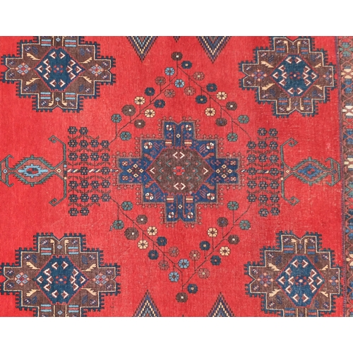 2039 - Blue and red ground rug with all over geometric design, 160cm x 133cm