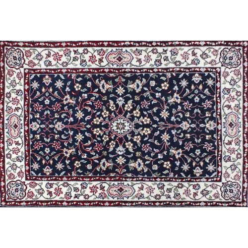 2072 - Rectangular persian rug having an all over floral design onto a blue and cream ground, 140cm x 92cm