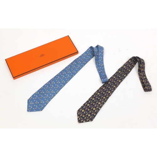 2620 - Two Hermes silk ties, one with box, decorated with monkey's and elephants, each 140cm in length