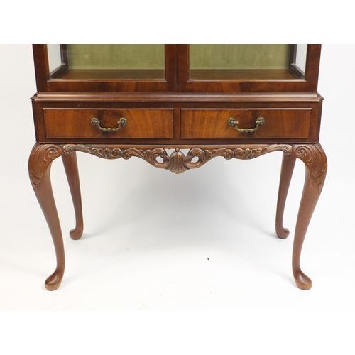 3 - Mahogany display cabinet with a pair of glazed doors enclosing two shelves above two frieze drawers,... 
