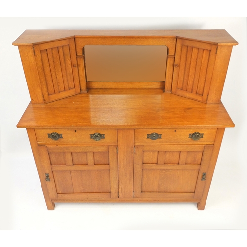 2076 - Arts & Crafts oak side cabinet with mirrored back, flanked by two cupboard doors above two drawers a... 