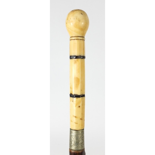 631 - Six wooden walking sticks including one with ivory handle and an African figure, the largest 115cm i... 