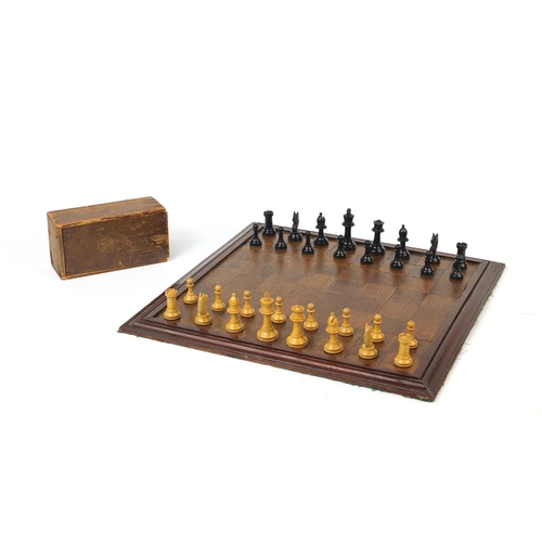 664 - Mostly boxwood and ebony chess pieces, with chess board, the largest piece 7.5cm high