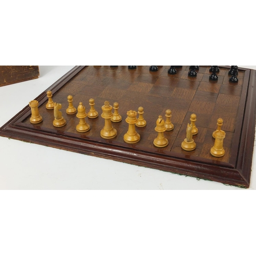 664 - Mostly boxwood and ebony chess pieces, with chess board, the largest piece 7.5cm high