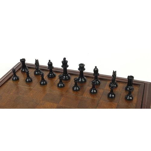 664 - Mostly boxwood and ebony chess pieces, with chess board, the largest piece 7.5cm high