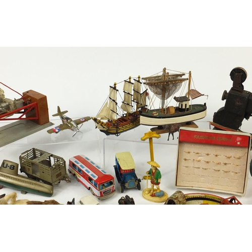 698 - Vintage toys including tin plate vehicles, a Mamod steam tractor, hand painted figures and a clockwo... 