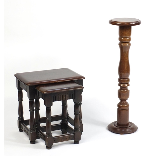 81 - Mahogany torchere and a nest of two tables, the torchere 85cm high