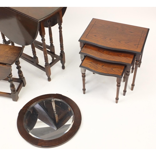 64 - Occasional furniture comprising two drop leaf tables, a circular oak framed mirror with bevelled gla... 