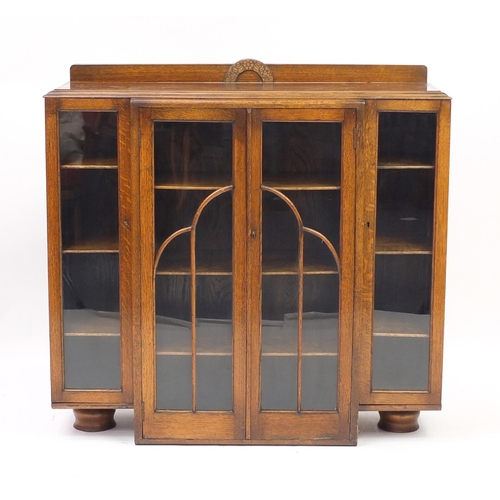 15 - Art Deco oak bookcase fitted with four glazed doors enclosing a series of shelves, 103cm H x 106cm W... 