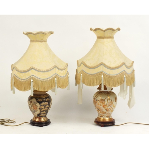 36 - Two Chinese porcelain table lamps with shades, the bases decorated with butterflies amongst flowers,... 