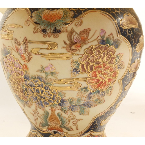36 - Two Chinese porcelain table lamps with shades, the bases decorated with butterflies amongst flowers,... 