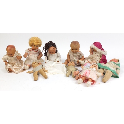 699 - Ten vintage composite dolls some with jointed limbs and open/close eyes, the largest 50cm high