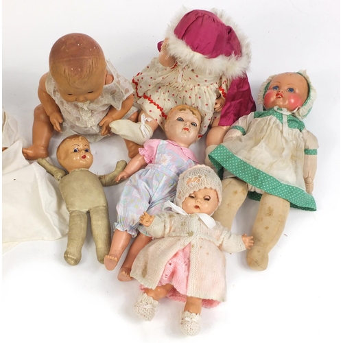 699 - Ten vintage composite dolls some with jointed limbs and open/close eyes, the largest 50cm high