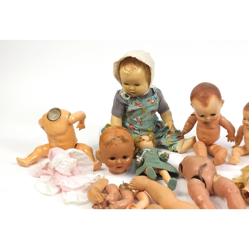 710 - Eight vintage composite dolls, some with jointed limbs and open/close eyes, the largest 60cm high